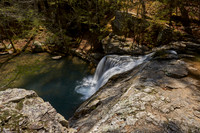Dappled Sunlight On A Waterfall